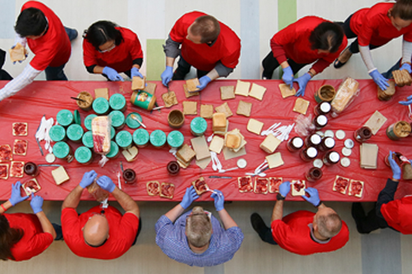 A group of volunteers make sandwiches