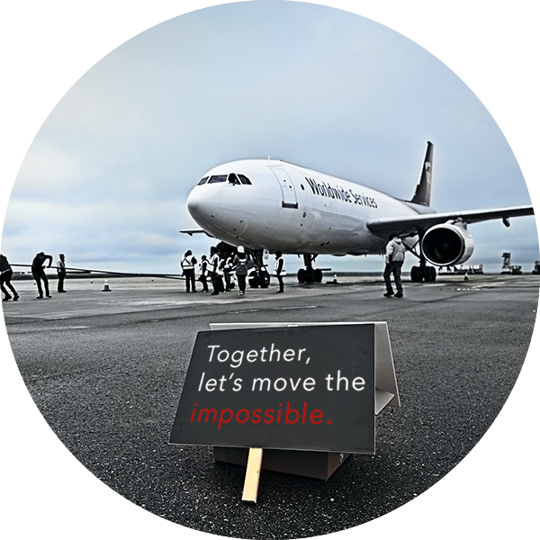 A plane with a sign in front that reads, ``Together, let's move the impossible.``