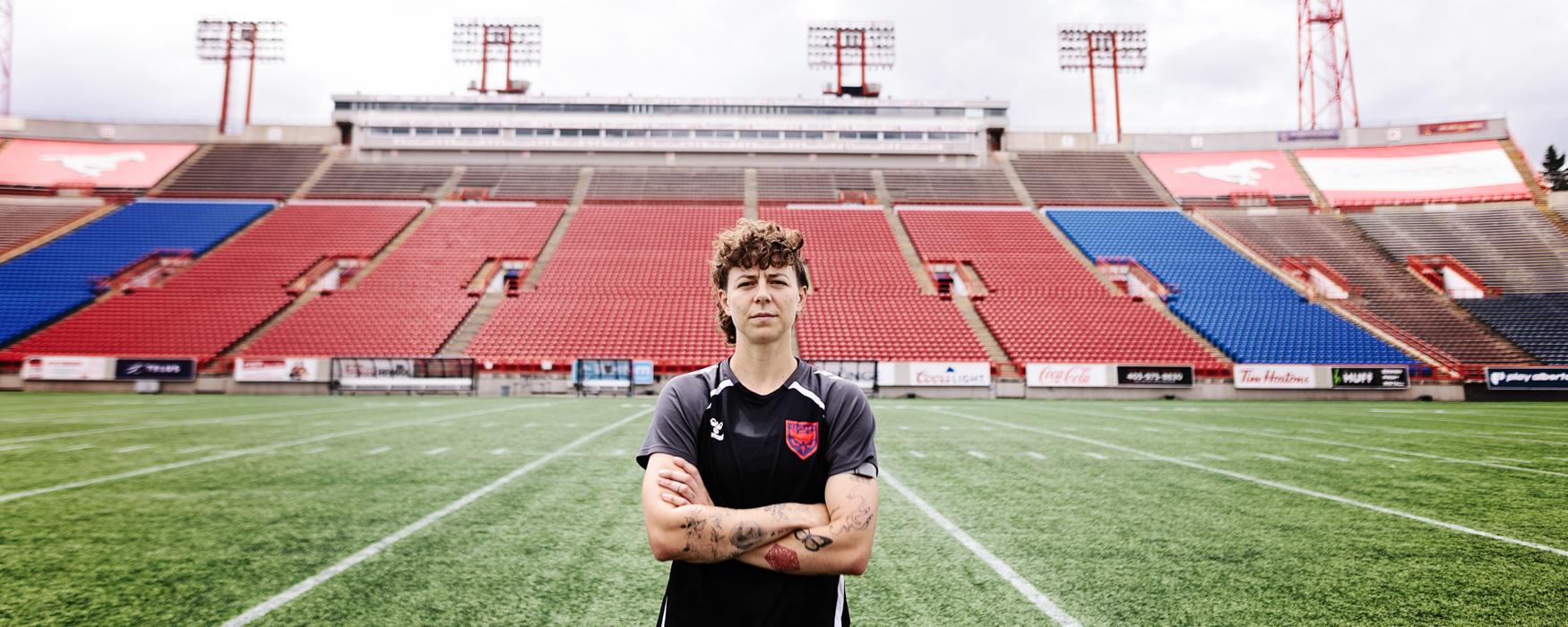 A Wild FC player stands at McMahon Stadium.